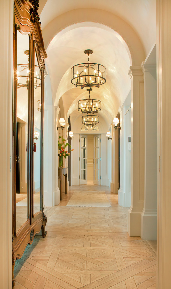 Traditional hallway in Omaha with beige walls, light hardwood floors and beige floor.