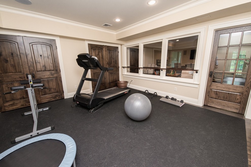 This is an example of a large beach style multipurpose gym in New York with beige walls and dark hardwood floors.