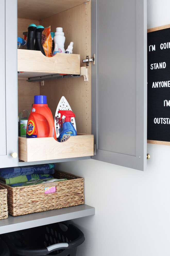 Inspiration for a small transitional dark wood floor and brown floor laundry room remodel in Chicago with gray cabinets, wood countertops and a side-by-side washer/dryer