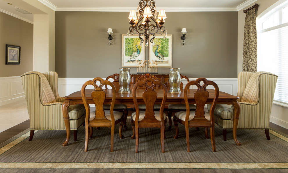 Example of a large transitional dark wood floor enclosed dining room design in Seattle with brown walls and no fireplace
