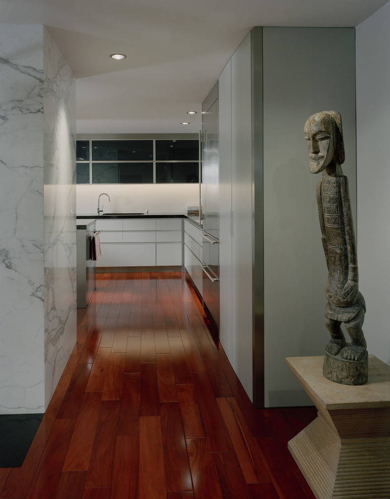 Contemporary hallway in Seattle with white walls and medium hardwood floors.
