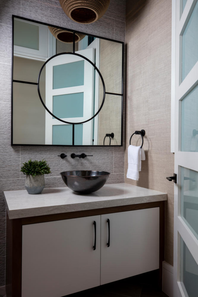 Photo of a large contemporary powder room in Miami with flat-panel cabinets, white cabinets, gray tile, porcelain tile, beige walls, a vessel sink, granite benchtops and grey benchtops.