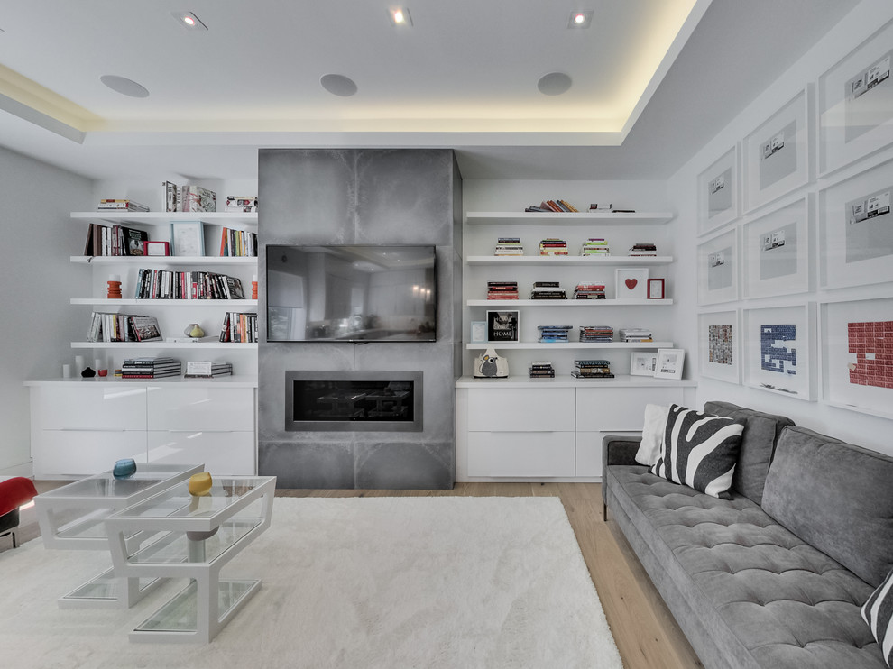 Design ideas for a contemporary family room in Toronto with white walls, medium hardwood floors, a ribbon fireplace and a wall-mounted tv.
