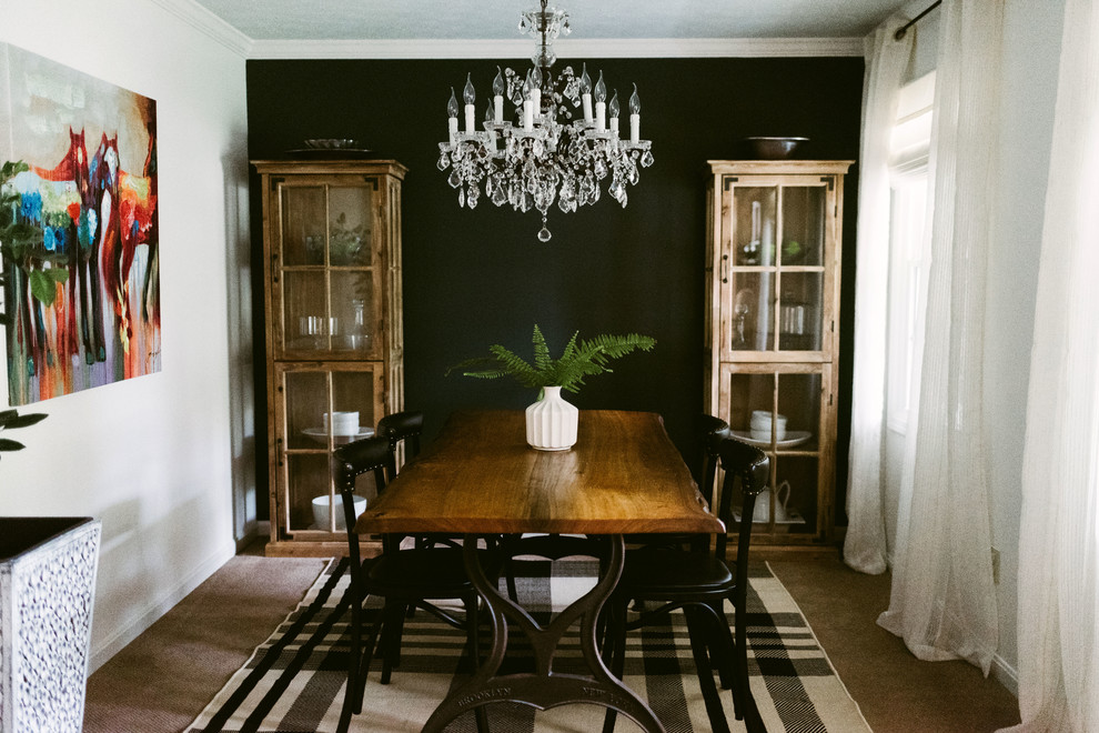 Design ideas for a small eclectic separate dining room in Houston with black walls.