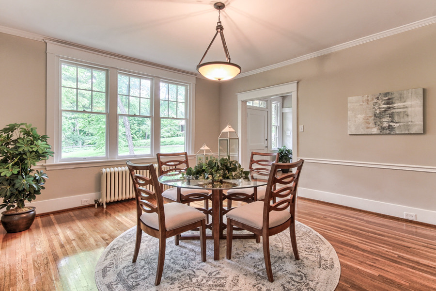 Arts and crafts separate dining room in Other with beige walls and light hardwood floors.