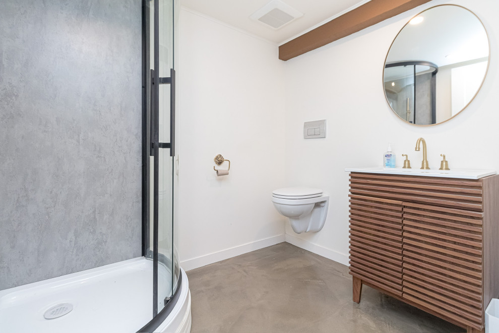Photo of a small contemporary shower room bathroom in Other with louvered cabinets, brown cabinets, a corner shower, a wall mounted toilet, beige walls, concrete flooring, a submerged sink, marble worktops, grey floors, a sliding door, white worktops, a laundry area, a single sink, a freestanding vanity unit and exposed beams.