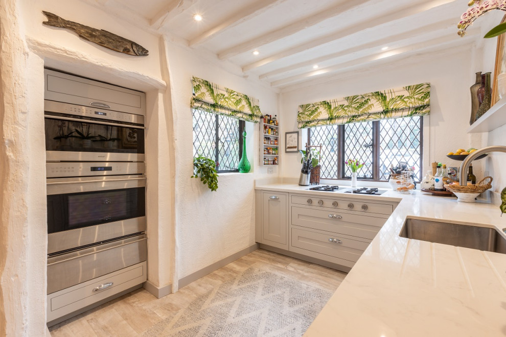 Medium sized traditional l-shaped kitchen/diner in Sussex with shaker cabinets, grey cabinets, engineered stone countertops, no island and white worktops.