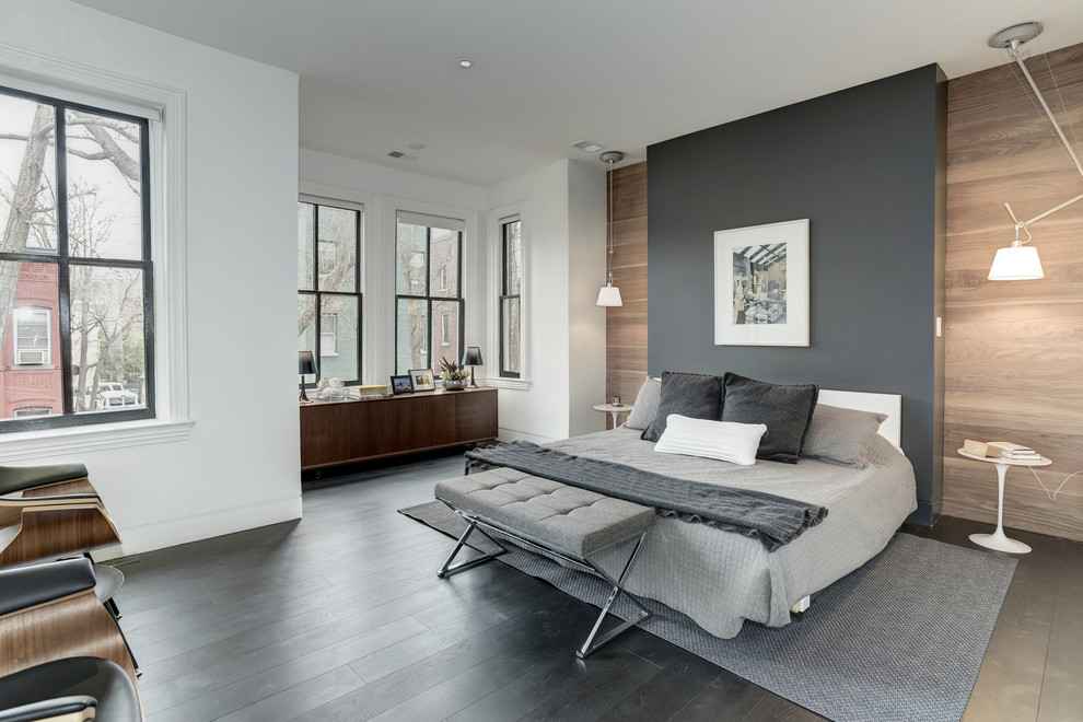 This is an example of a contemporary master bedroom in DC Metro with multi-coloured walls, dark hardwood floors and black floor.