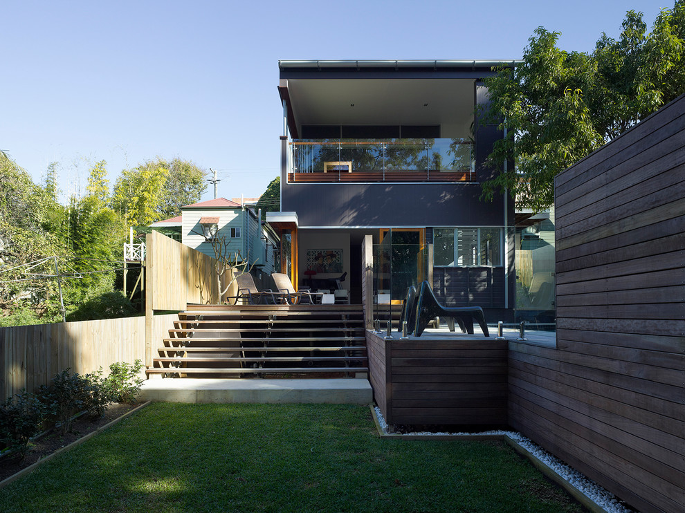 Inspiration for a contemporary two-storey exterior in Brisbane with mixed siding and a flat roof.