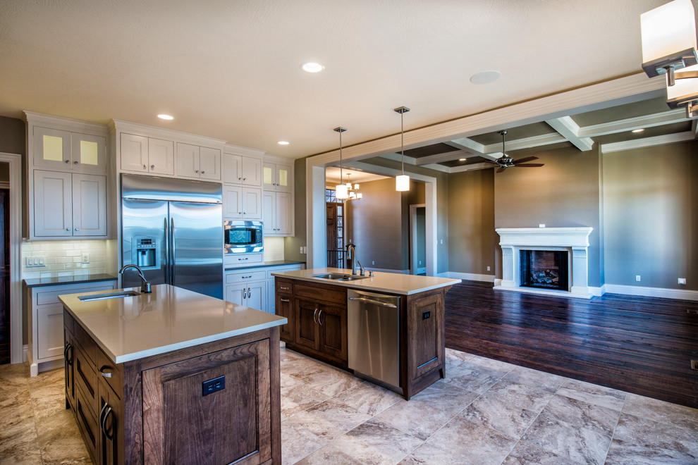 Inspiration for a large timeless l-shaped ceramic tile open concept kitchen remodel with an undermount sink, beaded inset cabinets, gray cabinets, quartz countertops, white backsplash, porcelain backsplash, stainless steel appliances and two islands