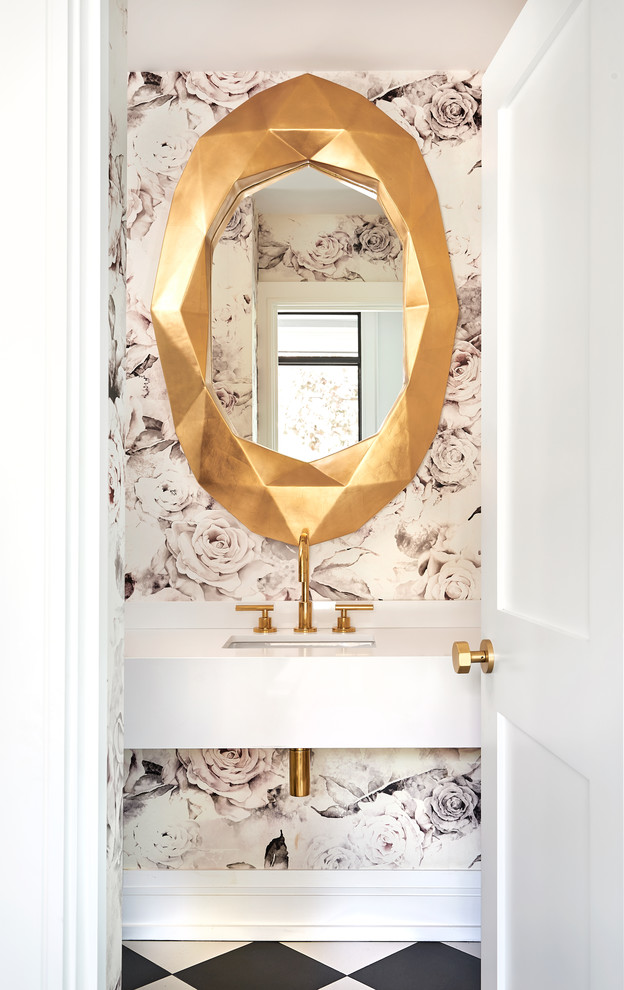 Transitional powder room in Toronto with pink walls, a wall-mount sink and black floor.