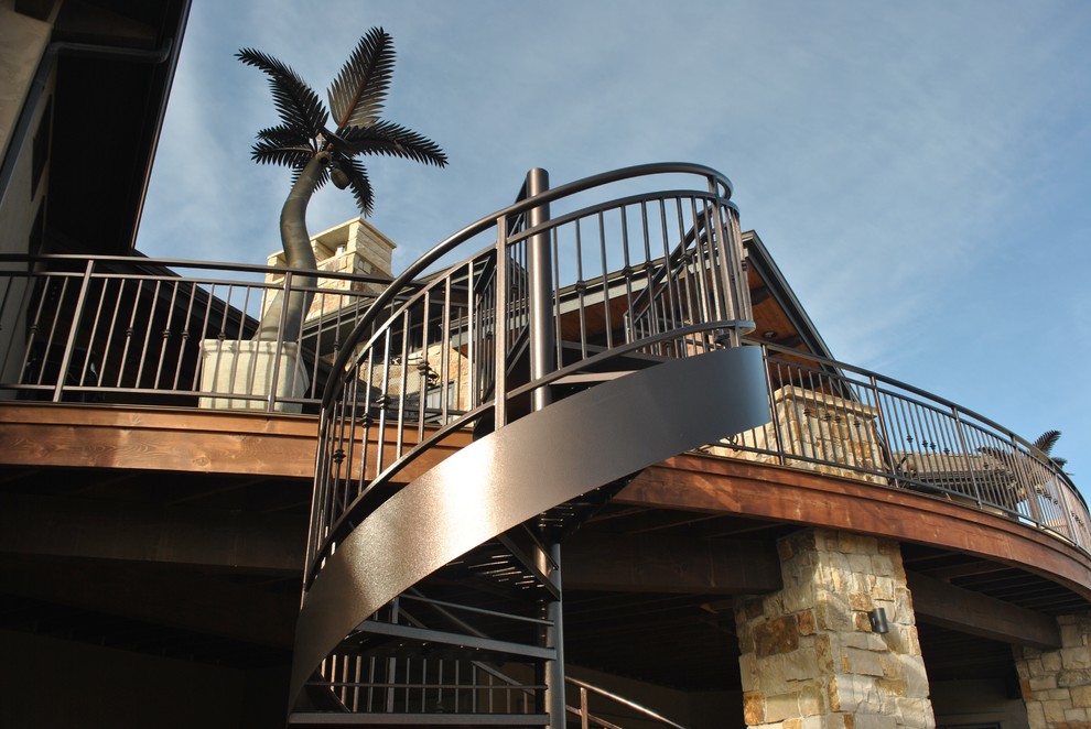 Photo of a mid-sized traditional metal spiral staircase in Denver with open risers and metal railing.