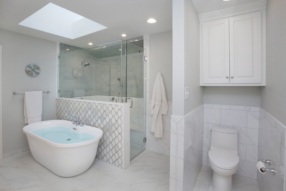 Inspiration for a traditional master bathroom in Dallas with raised-panel cabinets, white cabinets, a freestanding tub, a double shower, green tile, ceramic tile, grey walls, ceramic floors, a drop-in sink, engineered quartz benchtops, white floor, a hinged shower door, white benchtops and a one-piece toilet.