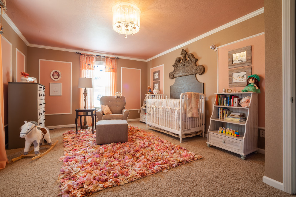 Mid-sized transitional girl carpeted and beige floor nursery photo in St Louis with pink walls