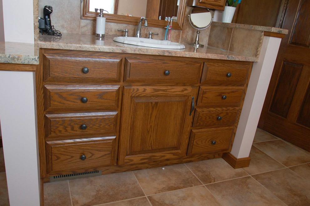 Inspiration for a mid-sized transitional master slate floor bathroom remodel with raised-panel cabinets, dark wood cabinets, white walls and a drop-in sink