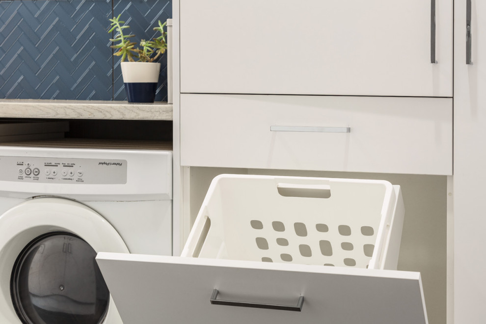 Design ideas for a small contemporary galley laundry cupboard in Melbourne with a drop-in sink, raised-panel cabinets, white cabinets, wood benchtops, white walls, ceramic floors, a side-by-side washer and dryer, grey floor and grey benchtop.