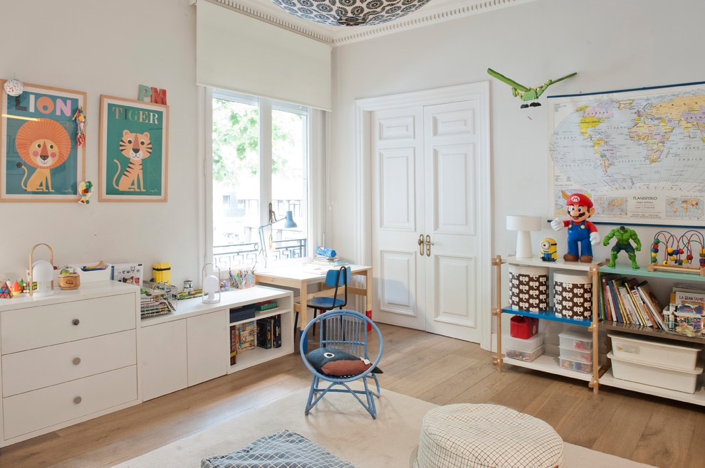 This is an example of a mid-sized transitional gender-neutral kids' playroom for kids 4-10 years old in Barcelona with grey walls, light hardwood floors and brown floor.