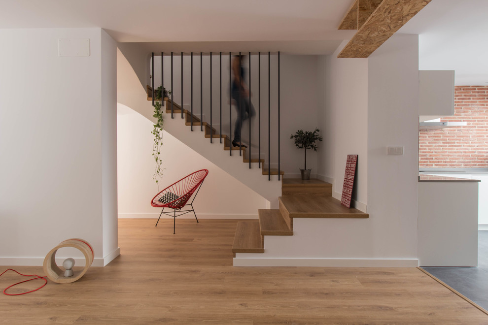 Mid-sized scandinavian wood u-shaped staircase in Other with wood risers.