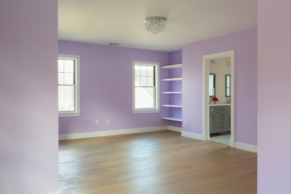 Design ideas for a large traditional guest bedroom in Boston with purple walls, light hardwood flooring and beige floors.