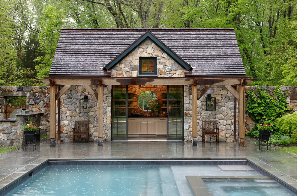 Inspiration for a mid-sized country rectangular pool in New York with a pool house.