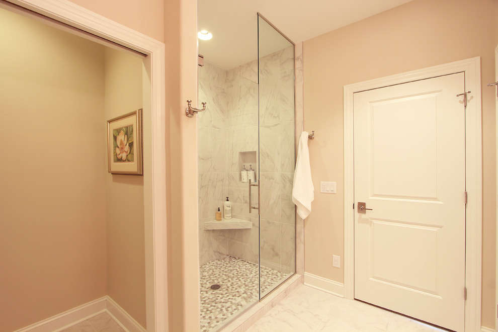 Photo of a mid-sized traditional master bathroom in Other with recessed-panel cabinets, white cabinets, an alcove shower, a two-piece toilet, white tile, marble, beige walls, marble floors, an undermount sink, engineered quartz benchtops, white floor, a hinged shower door and beige benchtops.