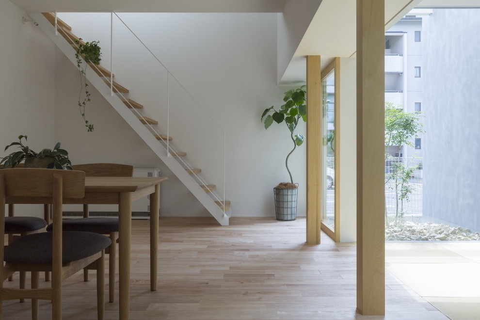 Mid-sized scandinavian wood straight staircase in Other with open risers and metal railing.