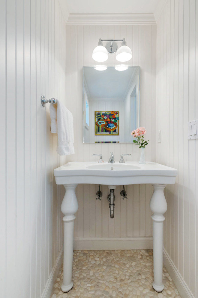 Example of a beach style pebble tile floor powder room design in New York