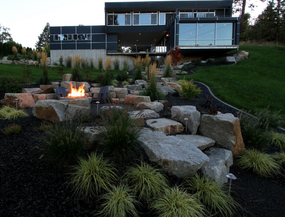 Inspiration for a mid-sized modern backyard full sun formal garden in Seattle with a fire feature and concrete pavers.