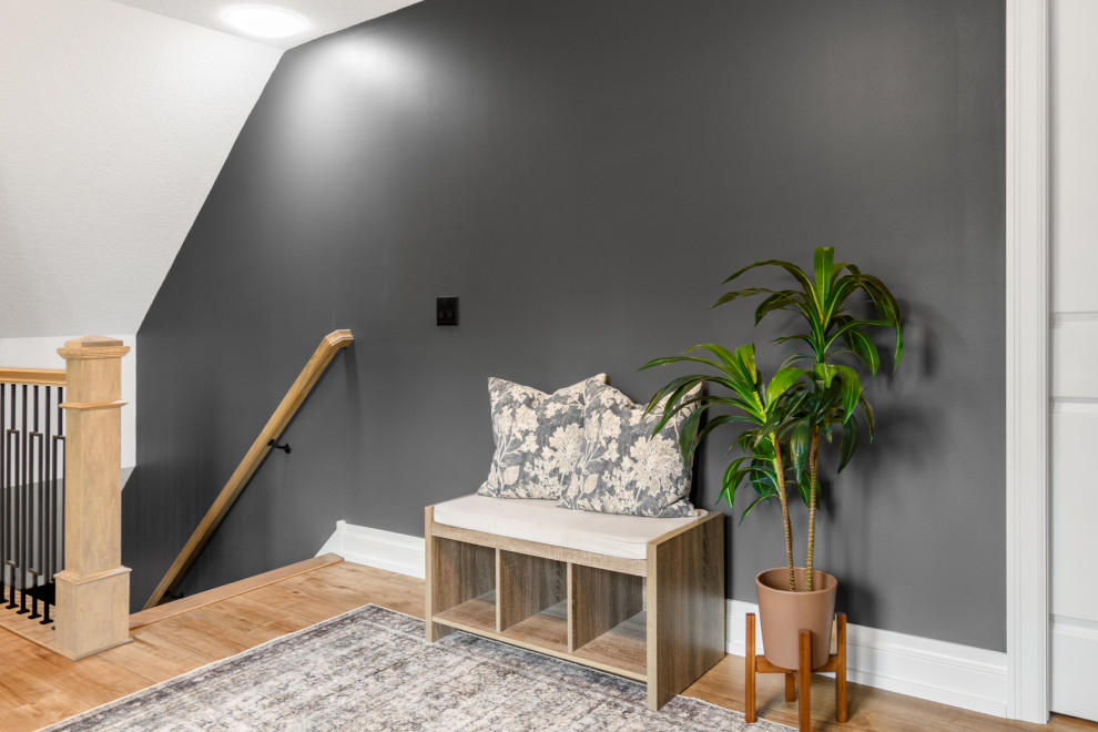Transitional light wood floor and beige floor entryway photo in Minneapolis with black walls