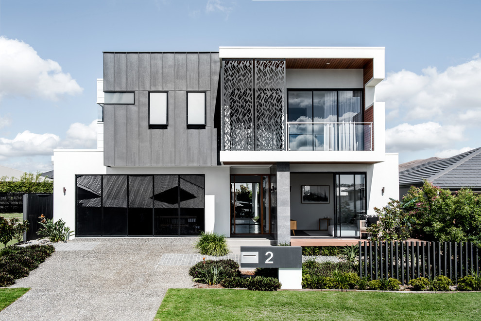 Photo of a contemporary two-storey white house exterior in Brisbane with mixed siding and a flat roof.