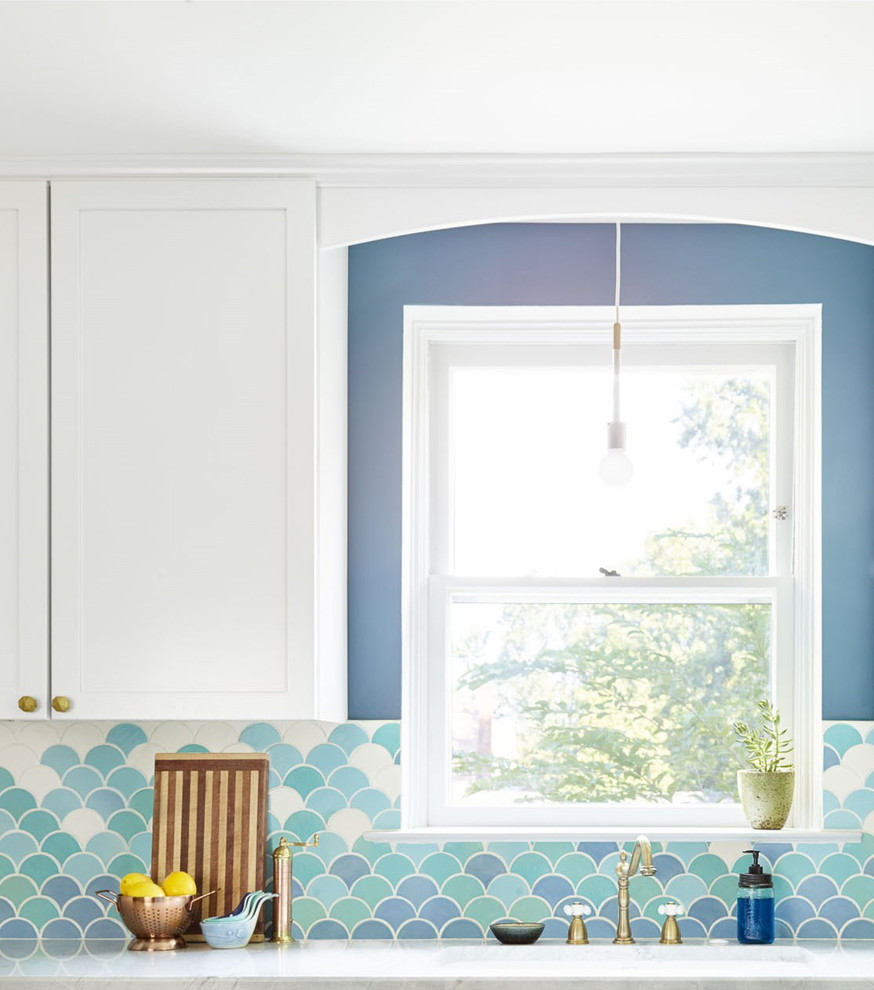 Inspiration for a mid-sized eclectic l-shaped eat-in kitchen in Philadelphia with an undermount sink, shaker cabinets, white cabinets, marble benchtops, blue splashback, ceramic splashback, white appliances, porcelain floors and no island.