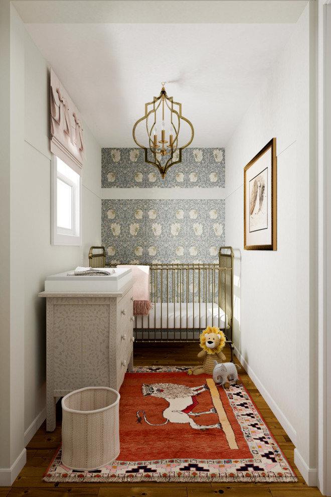 Small bohemian gender neutral nursery in San Francisco with white walls, medium hardwood flooring and wallpapered walls.