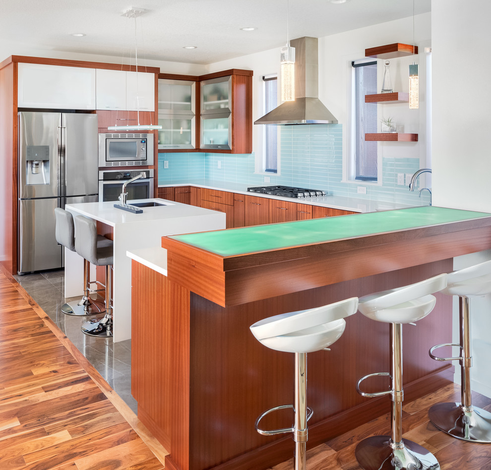 Mid-sized contemporary u-shaped open plan kitchen in Other with an undermount sink, flat-panel cabinets, medium wood cabinets, solid surface benchtops, blue splashback, ceramic splashback, stainless steel appliances, marble floors, with island, grey floor and white benchtop.