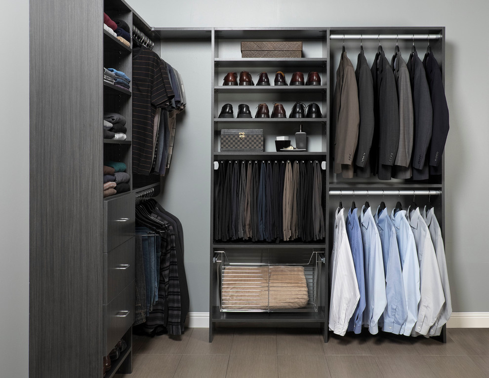 Inspiration for a mid-sized modern men's walk-in wardrobe in Toronto with flat-panel cabinets and dark wood cabinets.