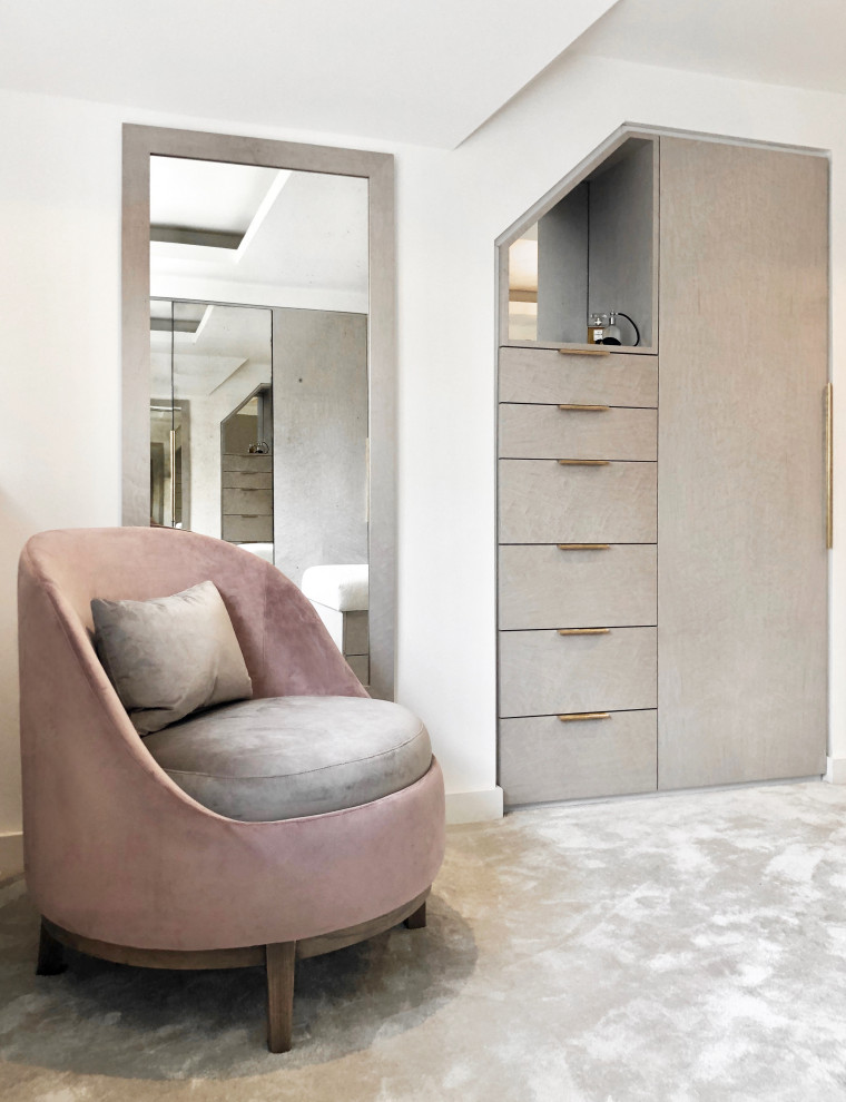 Photo of a large contemporary women's dressing room in Manchester with flat-panel cabinets, grey cabinets, carpet, grey floor and coffered.