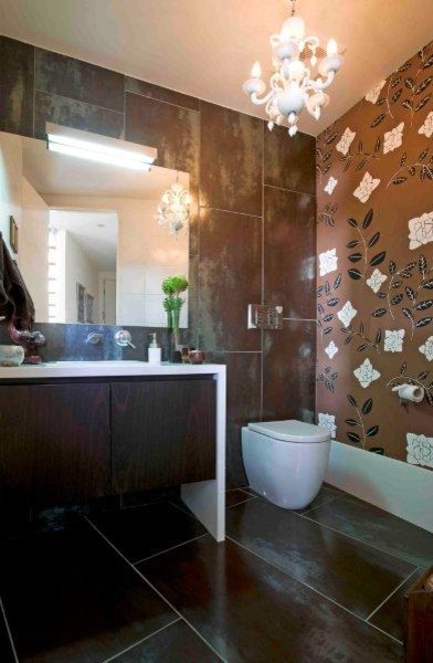 This is an example of a mid-sized contemporary powder room in Brisbane with a wall-mount toilet, brown tile, porcelain tile, brown walls, porcelain floors, an undermount sink and engineered quartz benchtops.
