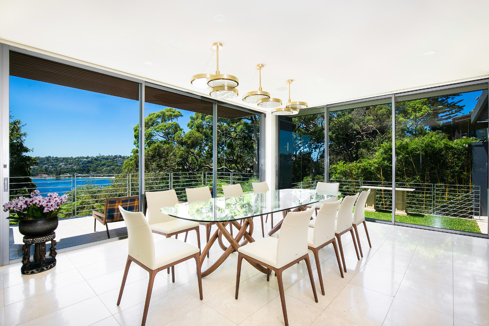 Photo of a contemporary dining room in Sydney with white walls and beige floor.