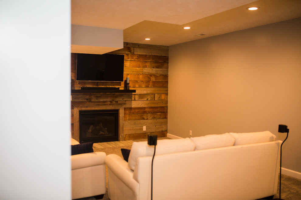Basement - mid-sized rustic underground carpeted and gray floor basement idea in Omaha with gray walls and a standard fireplace
