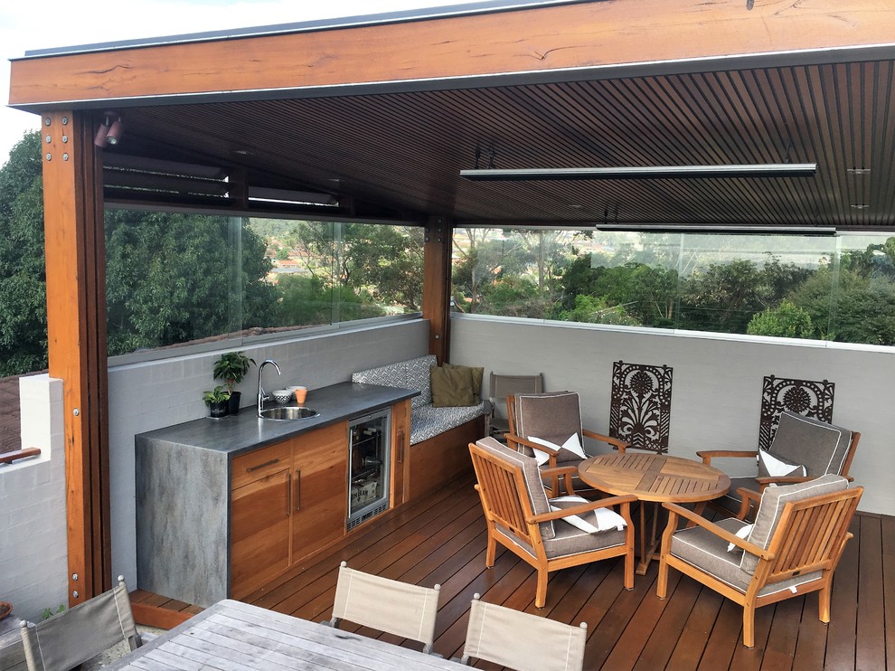 This is an example of a mid-sized contemporary rooftop balcony balcony in Wollongong with a pergola.