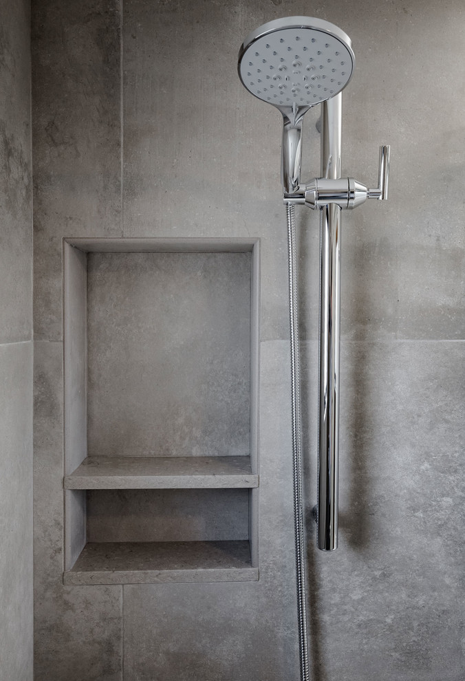 Inspiration for a small modern bathroom in Other with shaker cabinets, medium wood cabinets, an alcove shower, a one-piece toilet, beige tile, porcelain tile, white walls, porcelain floors, a wall-mount sink, beige floor and a sliding shower screen.