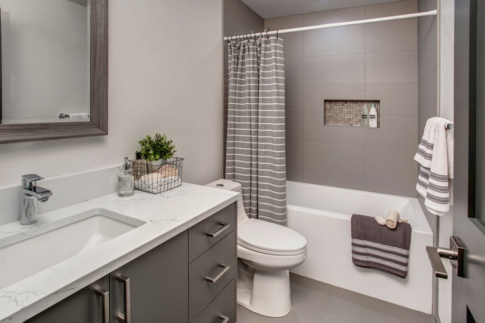 This is an example of a mid-sized modern 3/4 bathroom in Seattle with flat-panel cabinets, beige cabinets, a corner shower, a one-piece toilet, beige tile, ceramic tile, white walls, ceramic floors, an undermount sink, quartzite benchtops, beige floor, a hinged shower door, white benchtops, a single vanity, a built-in vanity and an alcove tub.