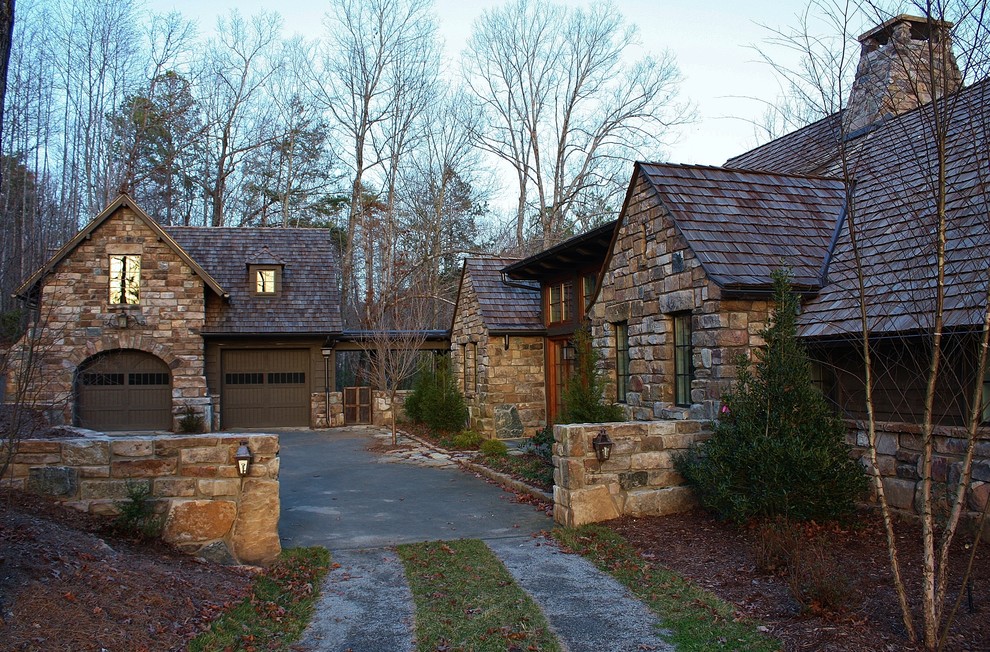 This is an example of a large country one-storey multi-coloured exterior in Other with stone veneer and a gable roof.