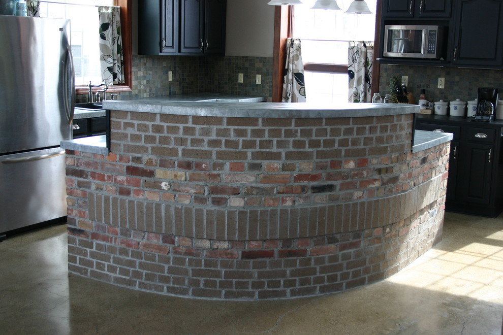 Eat-in kitchen - mid-sized transitional l-shaped concrete floor eat-in kitchen idea in Orange County with shaker cabinets, black cabinets, concrete countertops, multicolored backsplash, stone tile backsplash, stainless steel appliances and an island