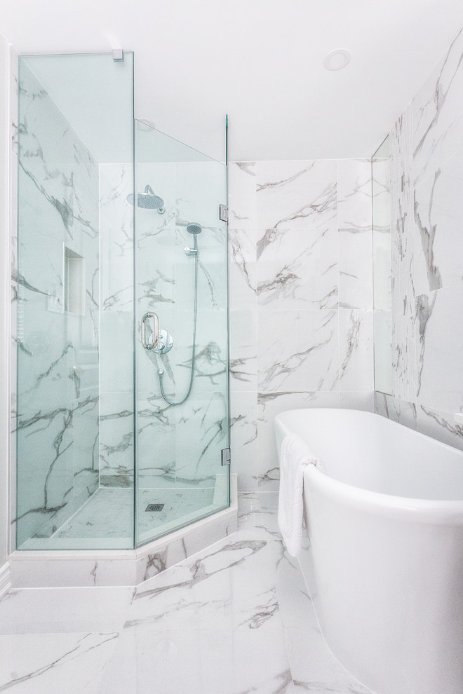 Small modern master bathroom in Toronto with shaker cabinets, grey cabinets, a freestanding tub, a corner shower, a one-piece toilet, white tile, porcelain tile, white walls, porcelain floors, an undermount sink, engineered quartz benchtops, white floor, a hinged shower door and white benchtops.