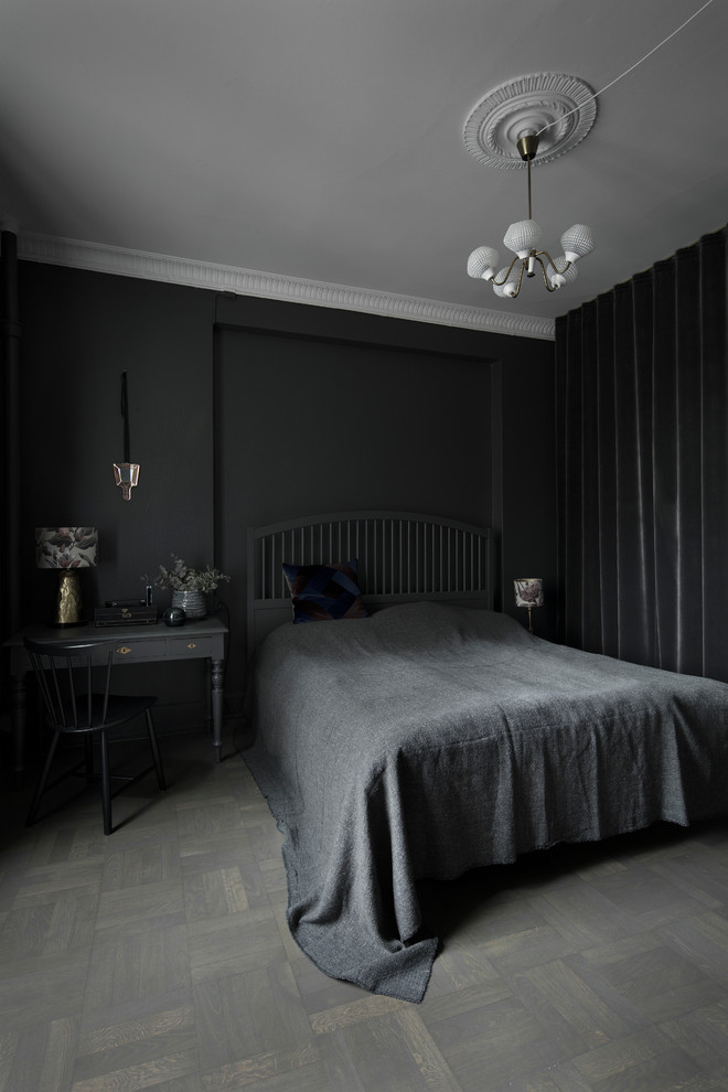 This is an example of a mid-sized transitional bedroom in Copenhagen with black walls, dark hardwood floors and grey floor.