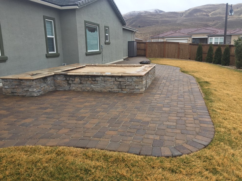 Mid-sized backyard concrete paver and custom-shaped aboveground hot tub photo