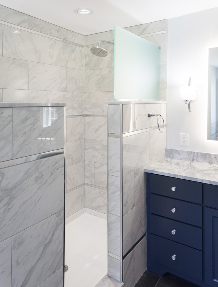 Photo of a large transitional master bathroom in Philadelphia with flat-panel cabinets, blue cabinets, a freestanding tub, an open shower, a two-piece toilet, gray tile, porcelain tile, grey walls, porcelain floors, an undermount sink, granite benchtops, grey floor, an open shower and grey benchtops.