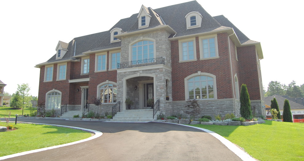 Photo of an expansive traditional two-storey brick exterior in Toronto.