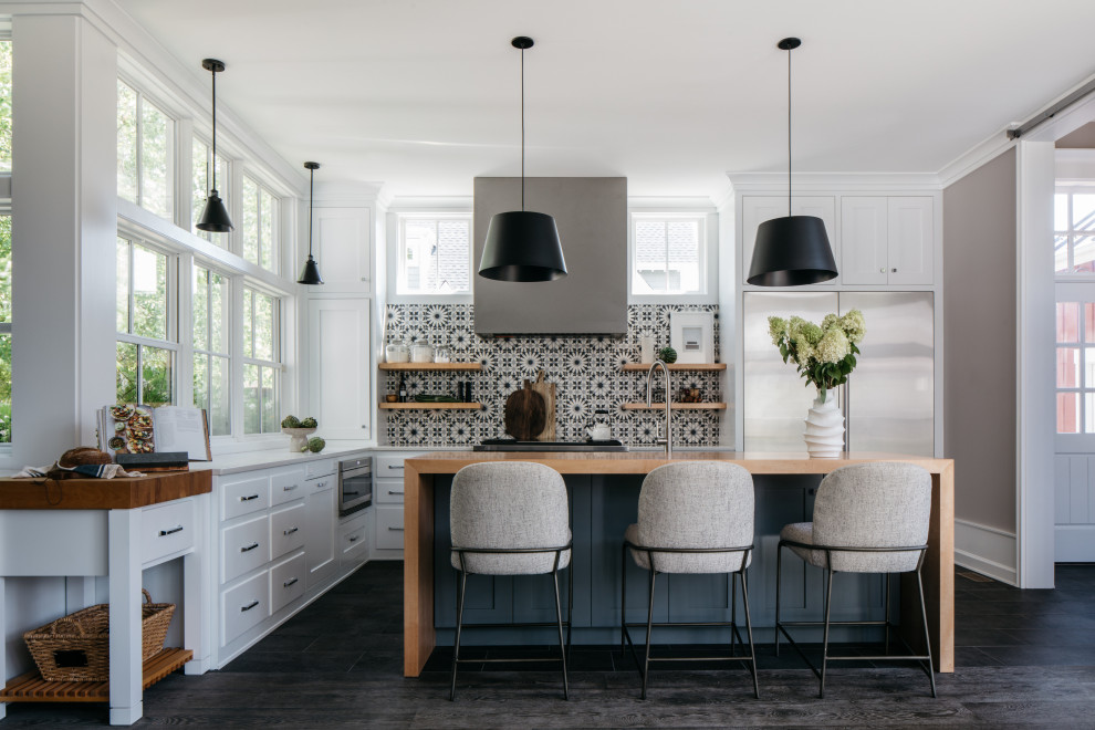 Large traditional l-shaped kitchen/diner in Chicago with shaker cabinets, white cabinets, quartz worktops, multi-coloured splashback, cement tile splashback, stainless steel appliances, an island, white worktops, a belfast sink, dark hardwood flooring, grey floors and a drop ceiling.