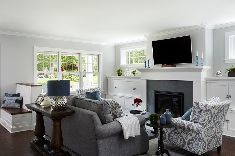 Photo of a mid-sized transitional formal open concept living room in Minneapolis with grey walls, a standard fireplace, a tile fireplace surround, a wall-mounted tv and dark hardwood floors.